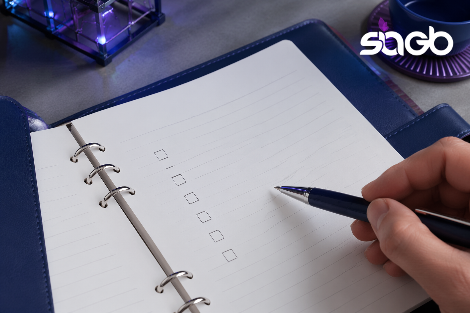 Hand holding a navy pen over an open planner with a blank checklist, representing prioritising retail problems before applying AI analytics